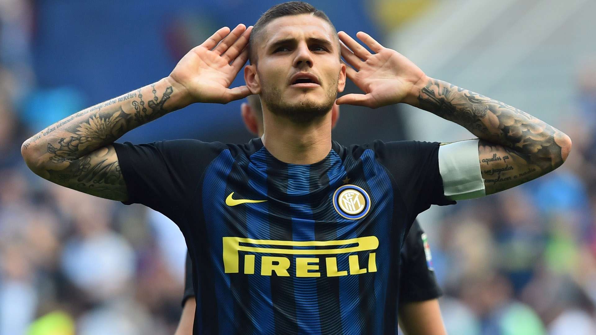 Mauro Icardi showing his visible forearm tattoos in a football kit
