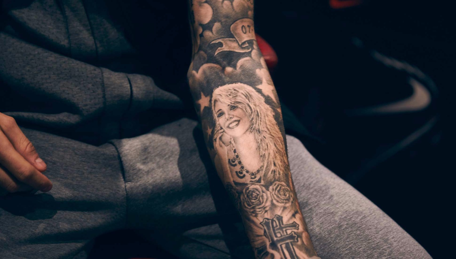 Close view of Mauro Icardi's forearm portrait, roses and lettering tattoos