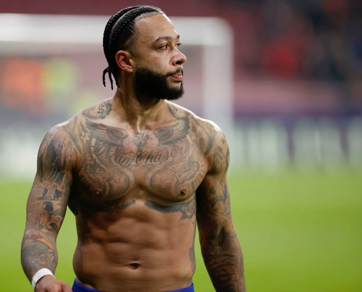 Memphis Depay chest and arm tattoos after a match
