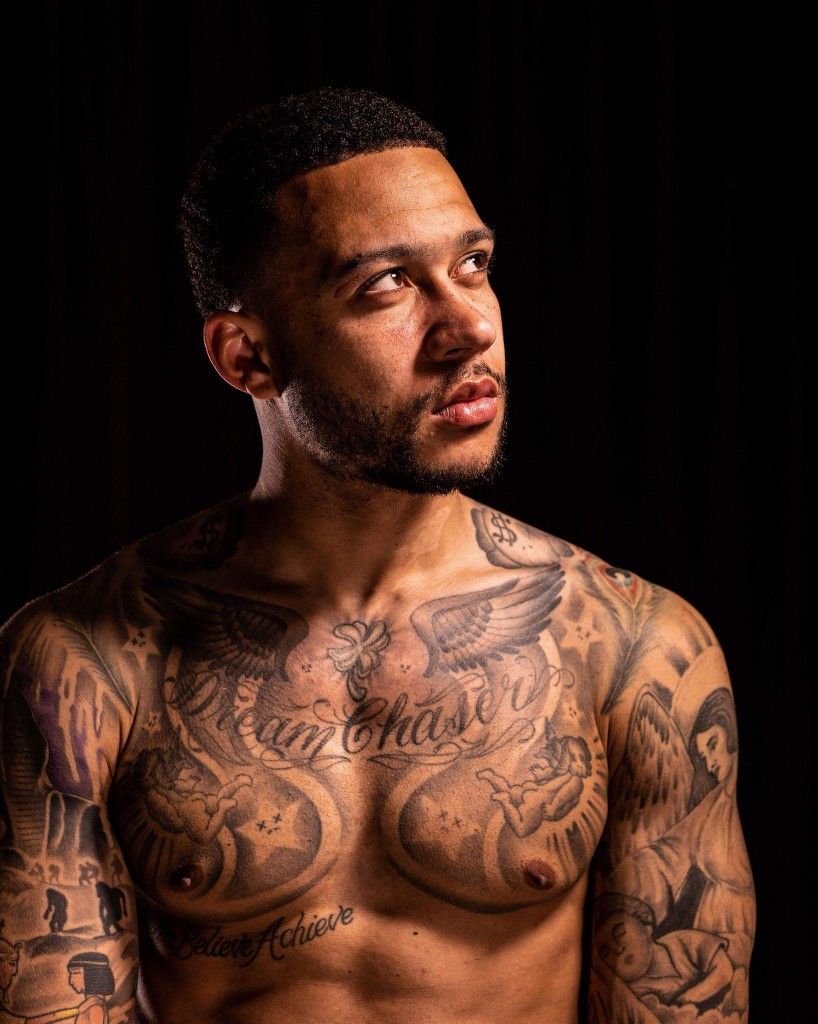 Memphis Depay winged chest and arm tattoos