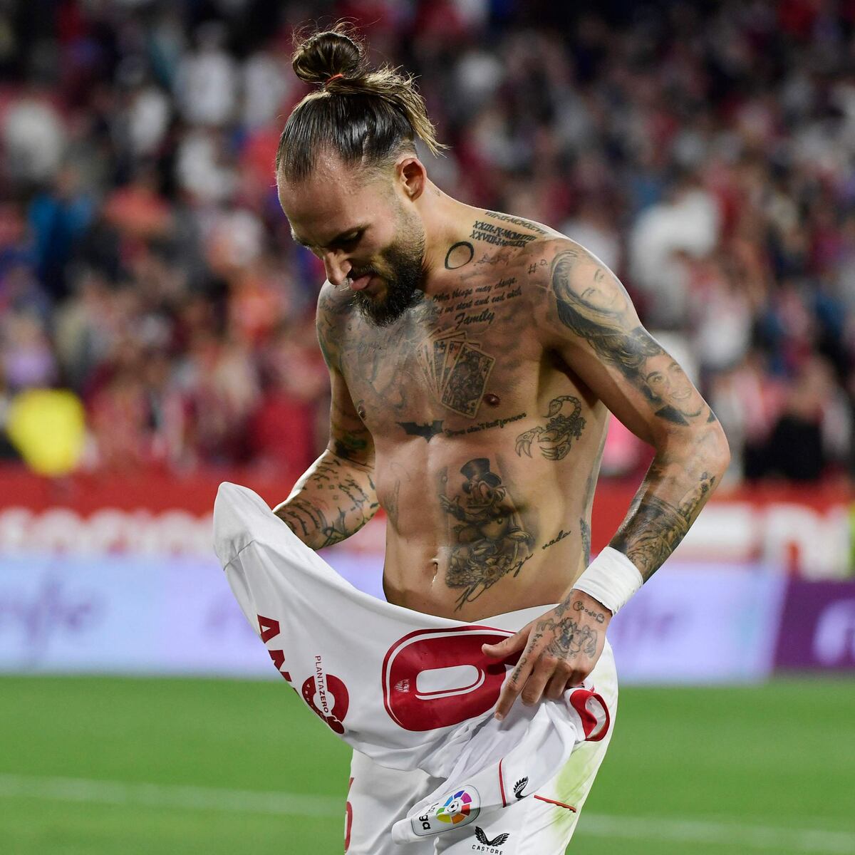 Nemanja Gudelj script quote tattoos across his chest and abdomen
