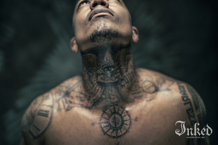 Nick Cannon shirtless portrait showing the compass tattoo on his chest and neck ink