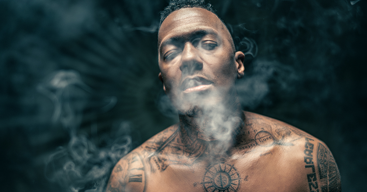 Nick Cannon portrait showing the compass chest tattoo and surrounding neck designs