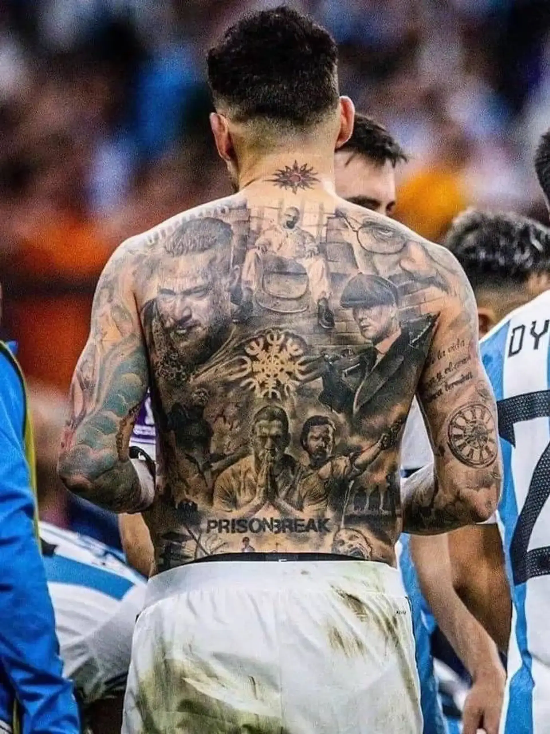 Nicolas Otamendi tattoos on his arms and upper body during a match