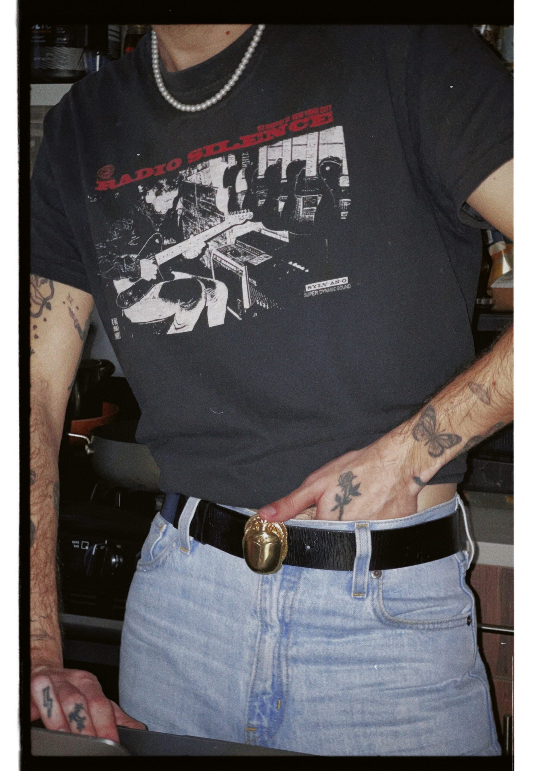 Nicolas McCoppin forearm tattoos including eye and lettering designs