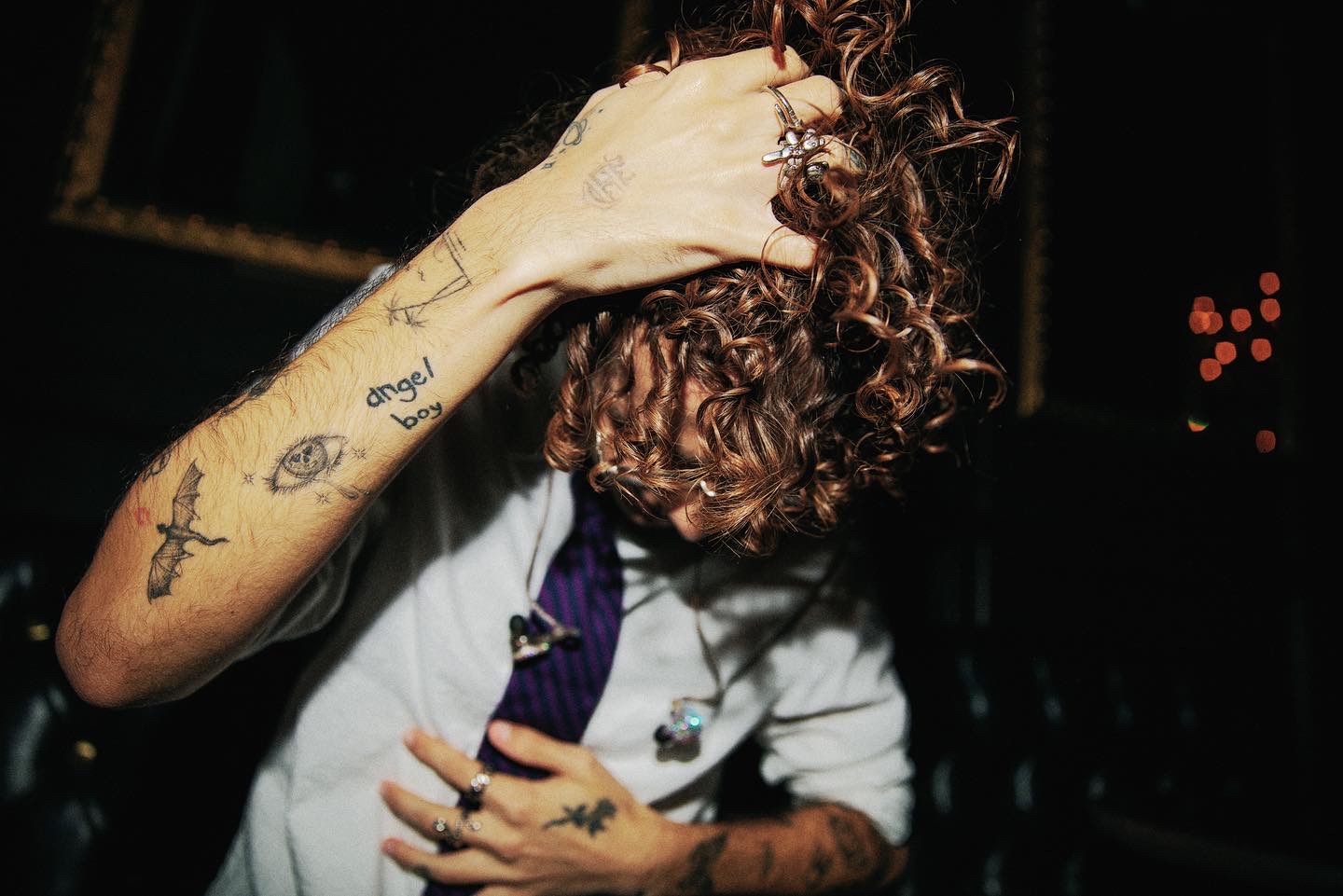 Nicolas McCoppin hand and chest tattoos in a close portrait