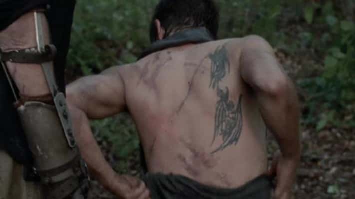 Norman Reedus showing a demon back tattoo