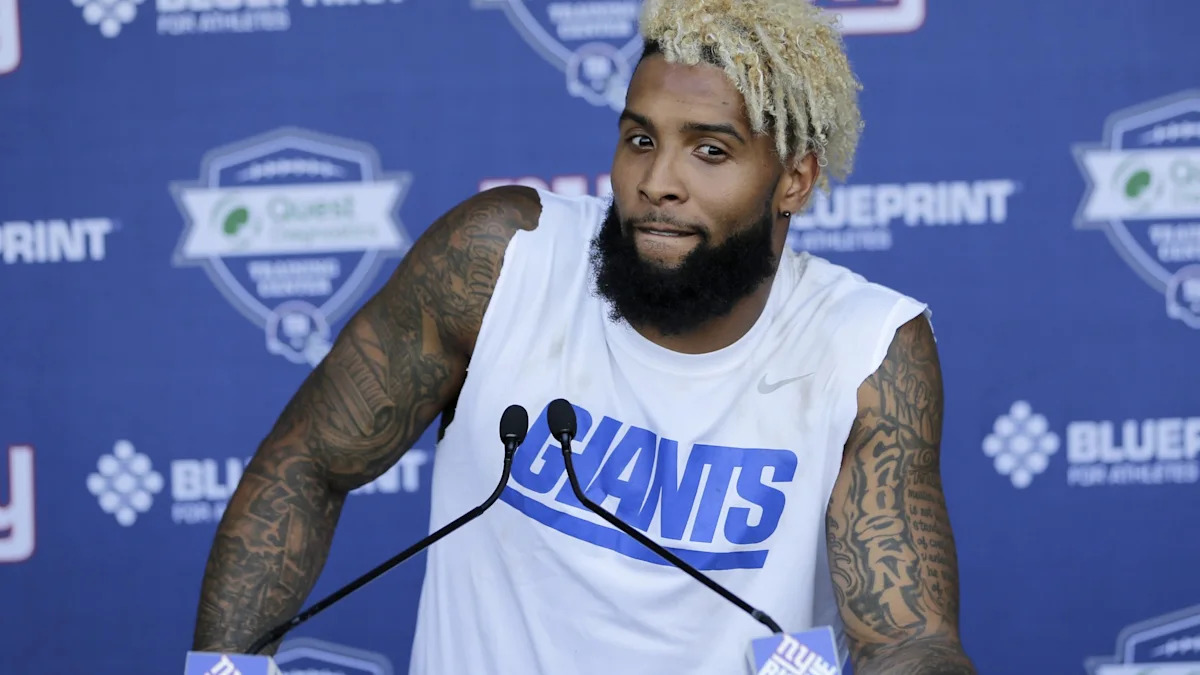 Odell Beckham Jr. showing arm tattoos and the style of his portrait-heavy ink