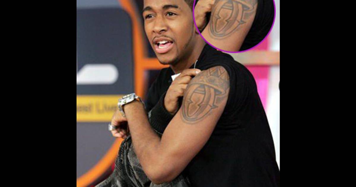 Omarion signature O upper arm tattoo