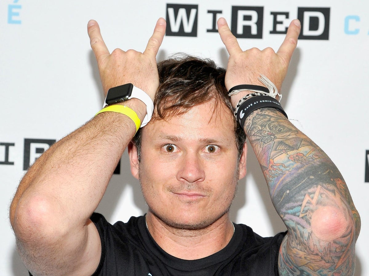 Tom DeLonge with his colorful right-arm tattoo sleeve visible