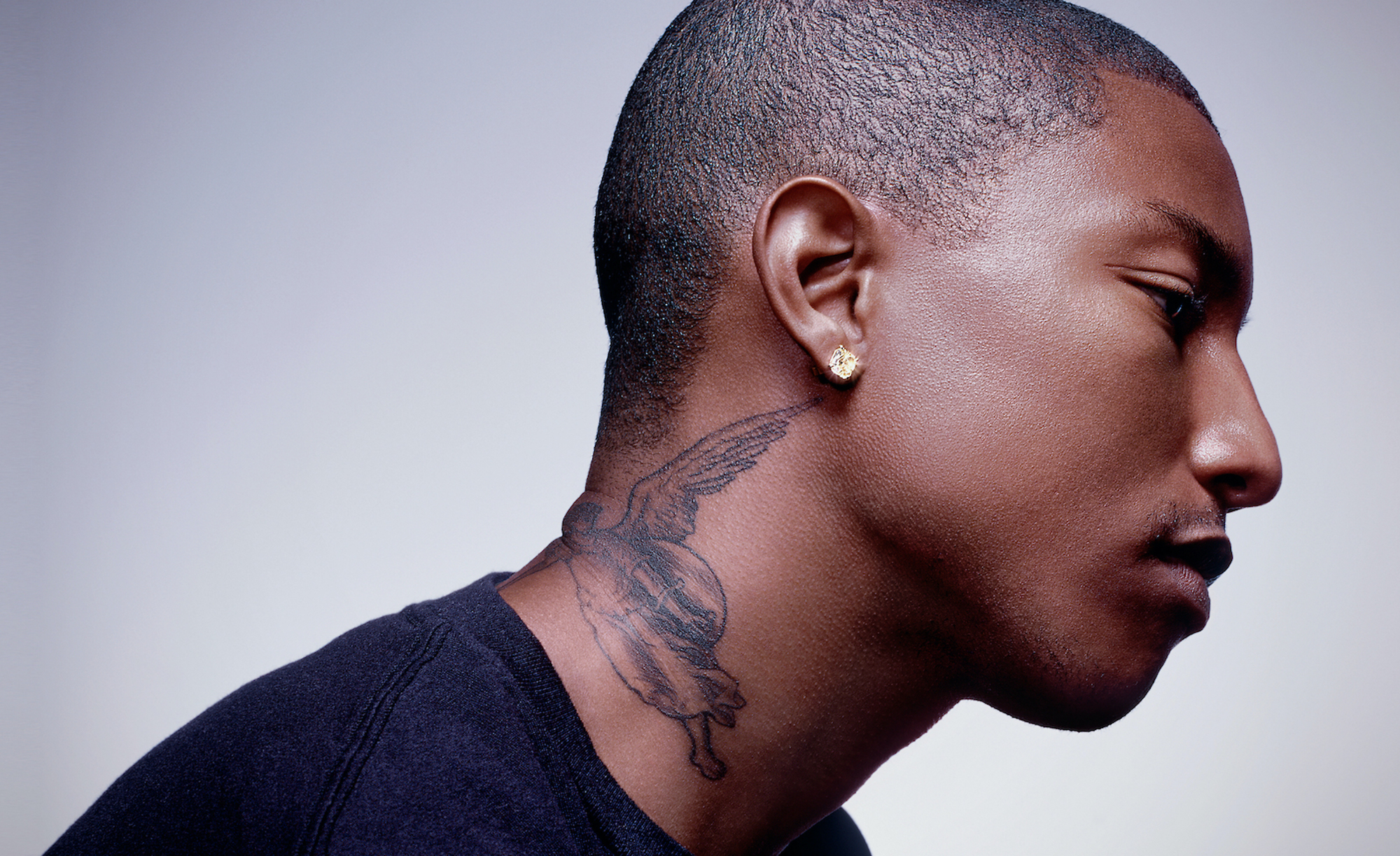 Pharrell Williams portrait showing his neck tattoo