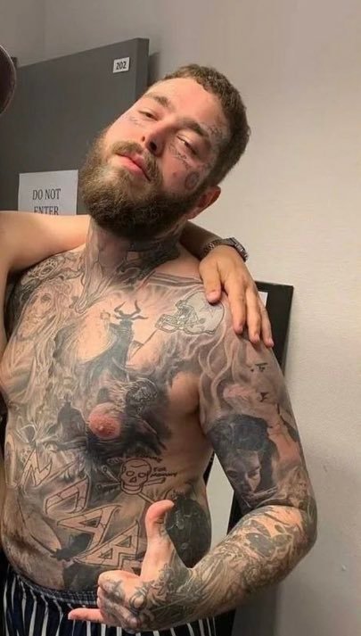 Post Malone showing the chest and stomach tattoo collection
