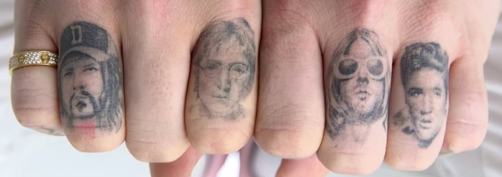 Post Malone portrait tattoos across the fingers