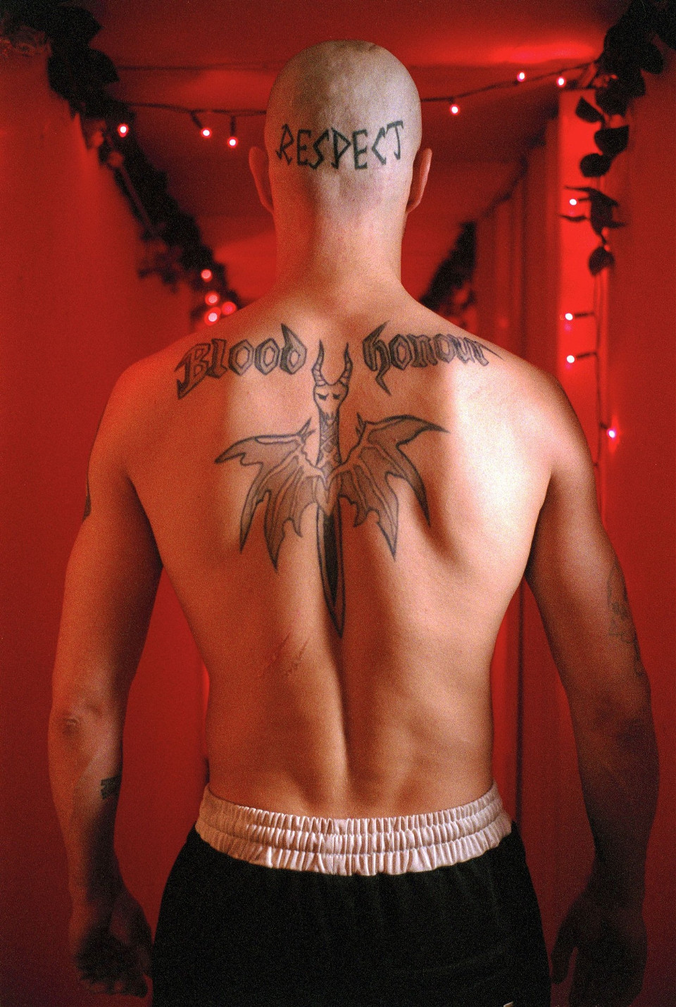 Mads Mikkelsen as Tonny showing the RESPECT tattoo across the back of his shaved scalp
