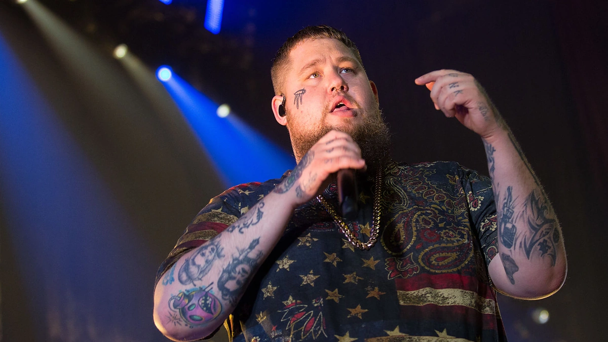 Rag’n’Bone Man tribal sleeve and forearm lettering tattoos