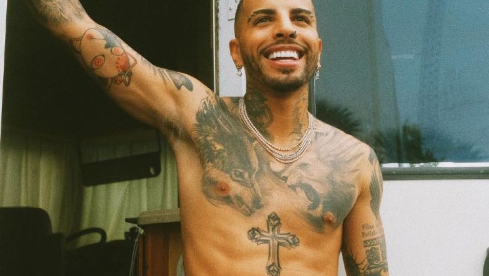 Rauw Alejandro lion and wolf chest tattoos