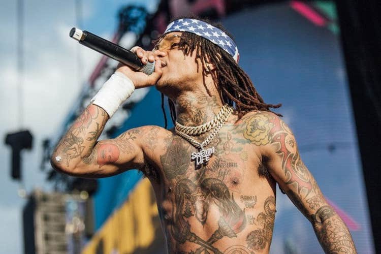 Swae Lee performance photo showing his chest and arm tattoos