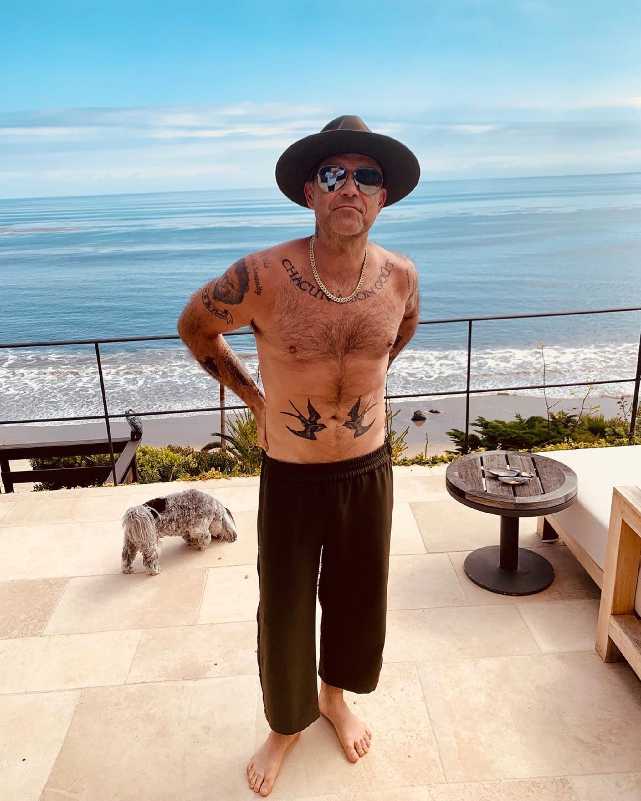 Robbie Williams torso tattoos and chest lettering