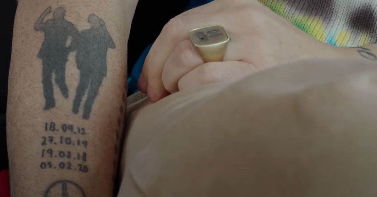 Robbie Williams tattoo close-up with script and portrait