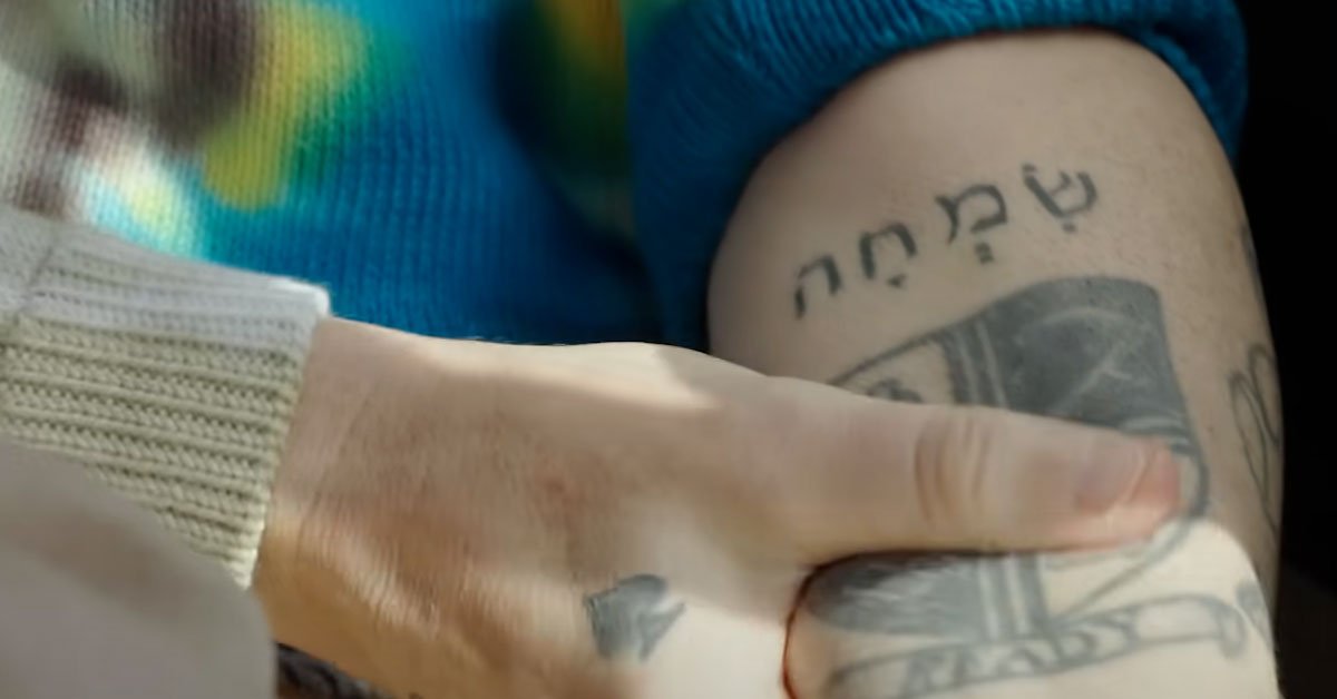 Robbie Williams tattoo close-up with dates and figures