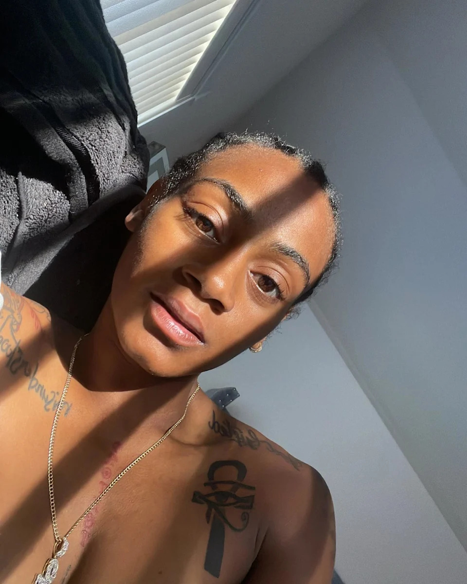 Sha’Carri Richardson ankh and eye chest tattoos
