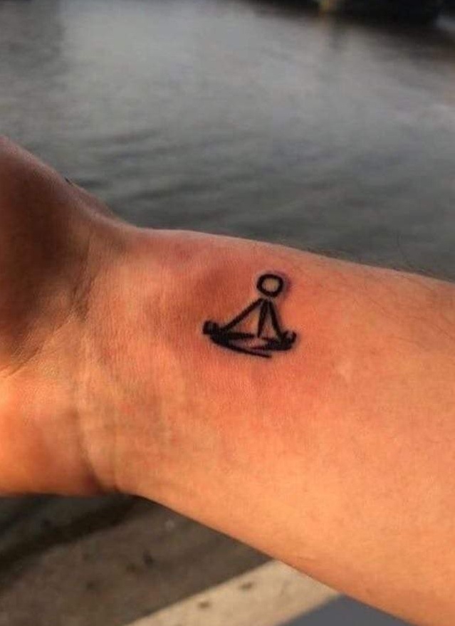 Shawn Mendes meditating figure wrist tattoo