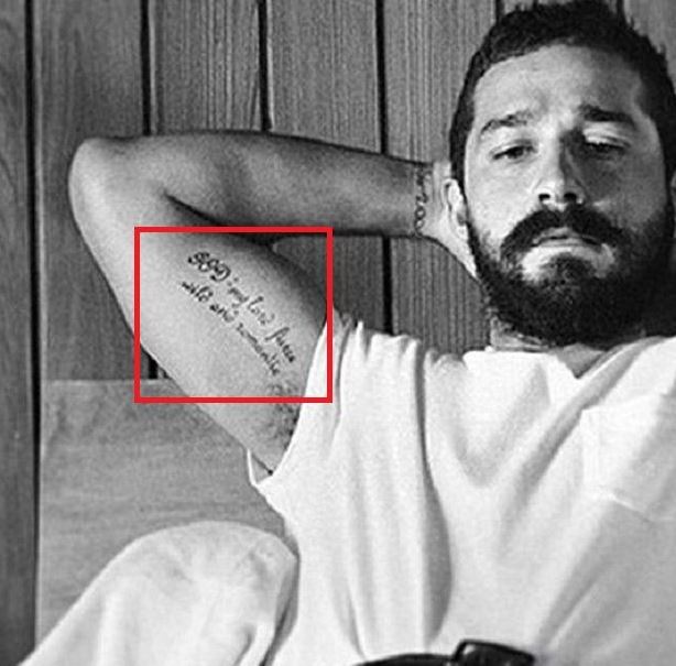 Shia LaBeouf showing the GOD script bicep tattoo