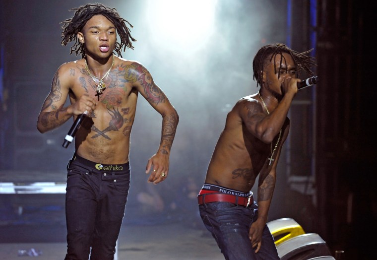 Slim Jxmmi stage chest and arm tattoos