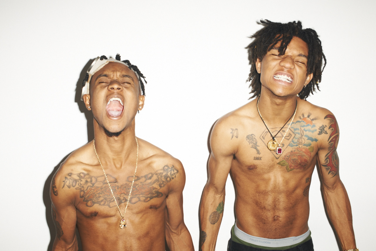 Slim Jxmmi portrait with visible tattoos