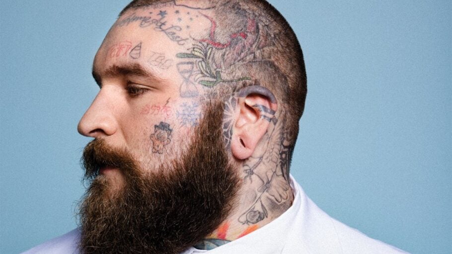 Teddy Swims profile showing head and neck tattoos