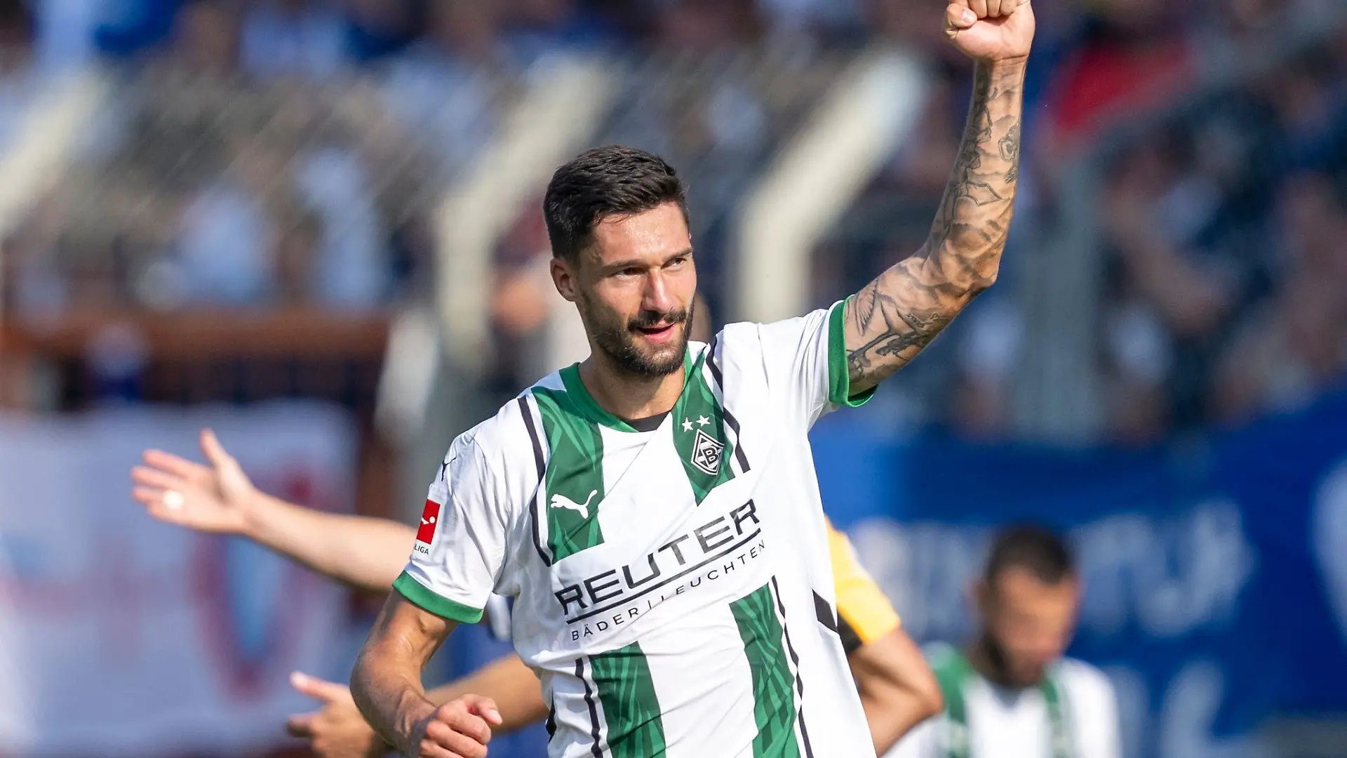 Tim Kleindienst tattooed arm raised during a football match