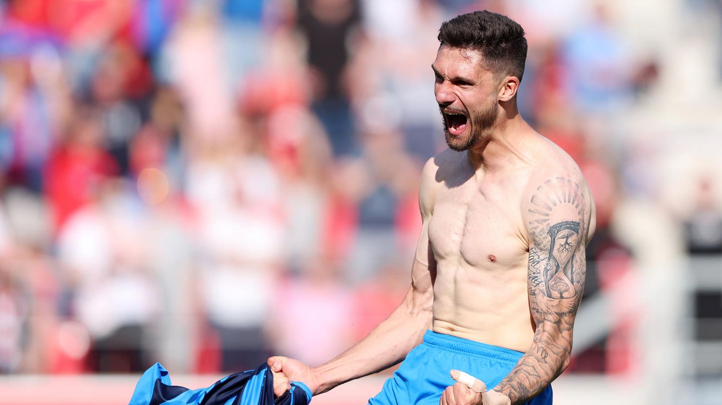 Tim Kleindienst shirtless celebration showing black and grey arm tattoos