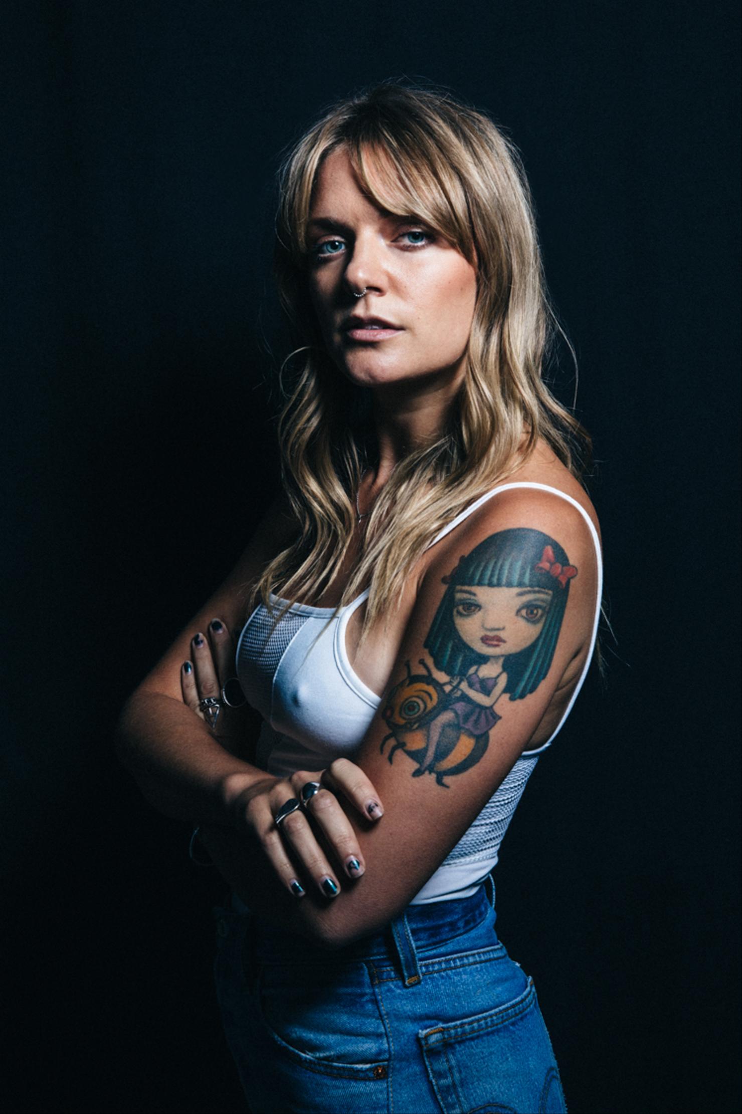 Tove Lo girl riding a bee tattoo on her upper arm