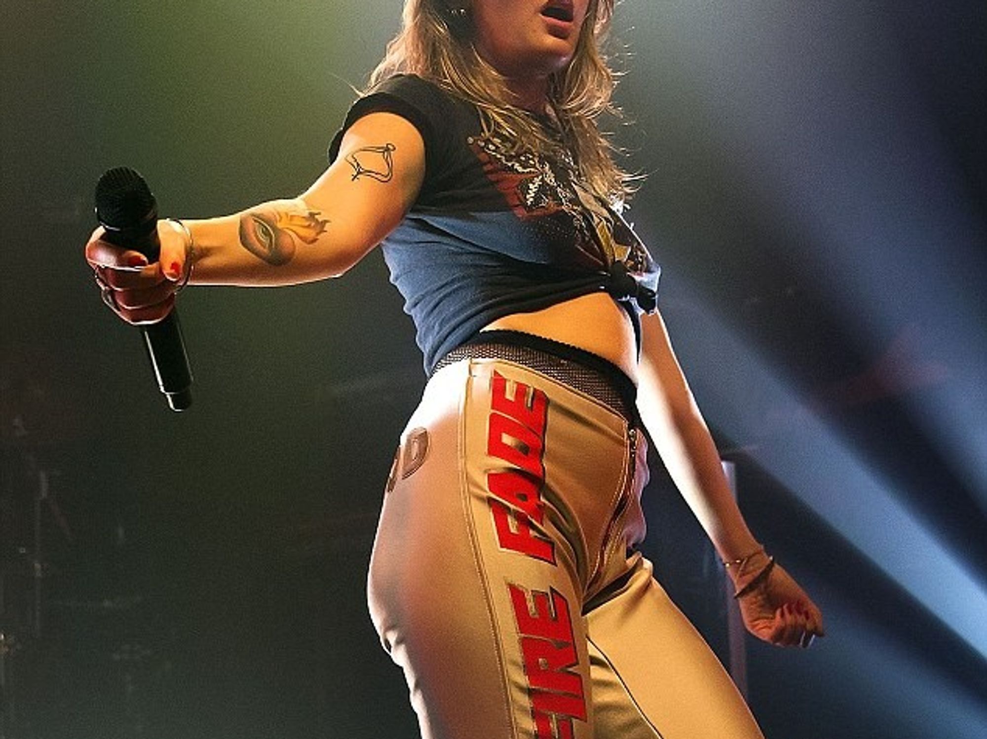 Tove Lo eye and flaming heart forearm tattoo