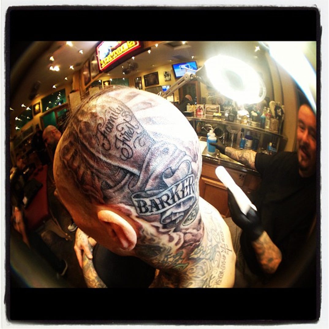 Close profile showing Travis Barker’s scalp, head and neck tattoos