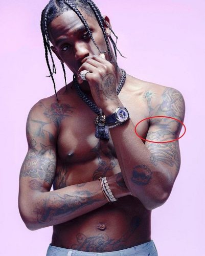 Travis Scott full moon over bat tattoo on his upper arm