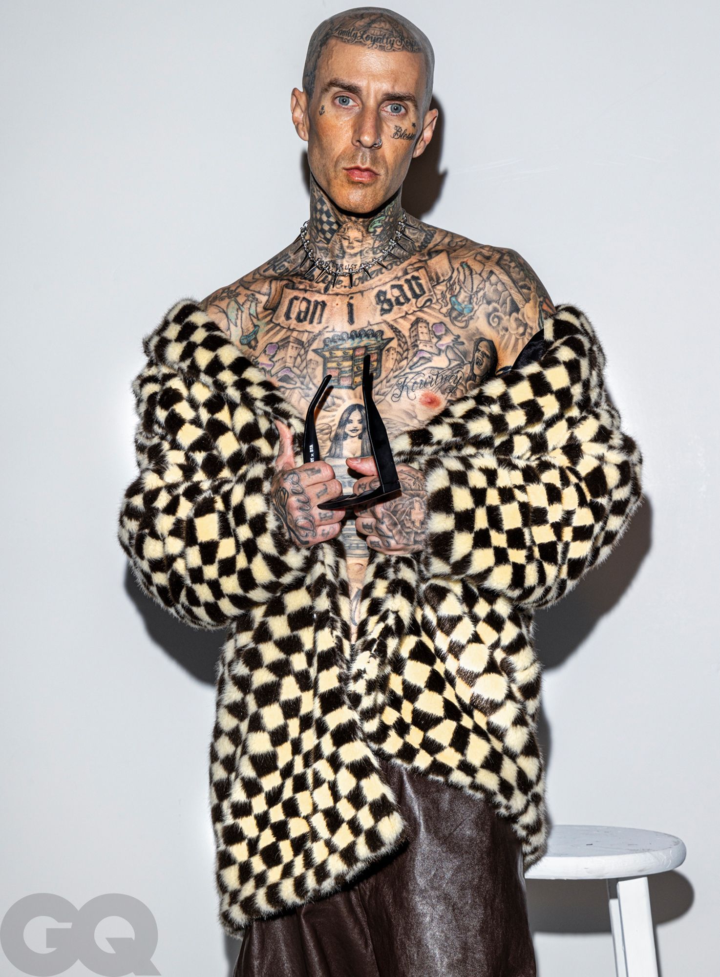 Travis Barker’s torso tattoos, including chest and ribcage lettering