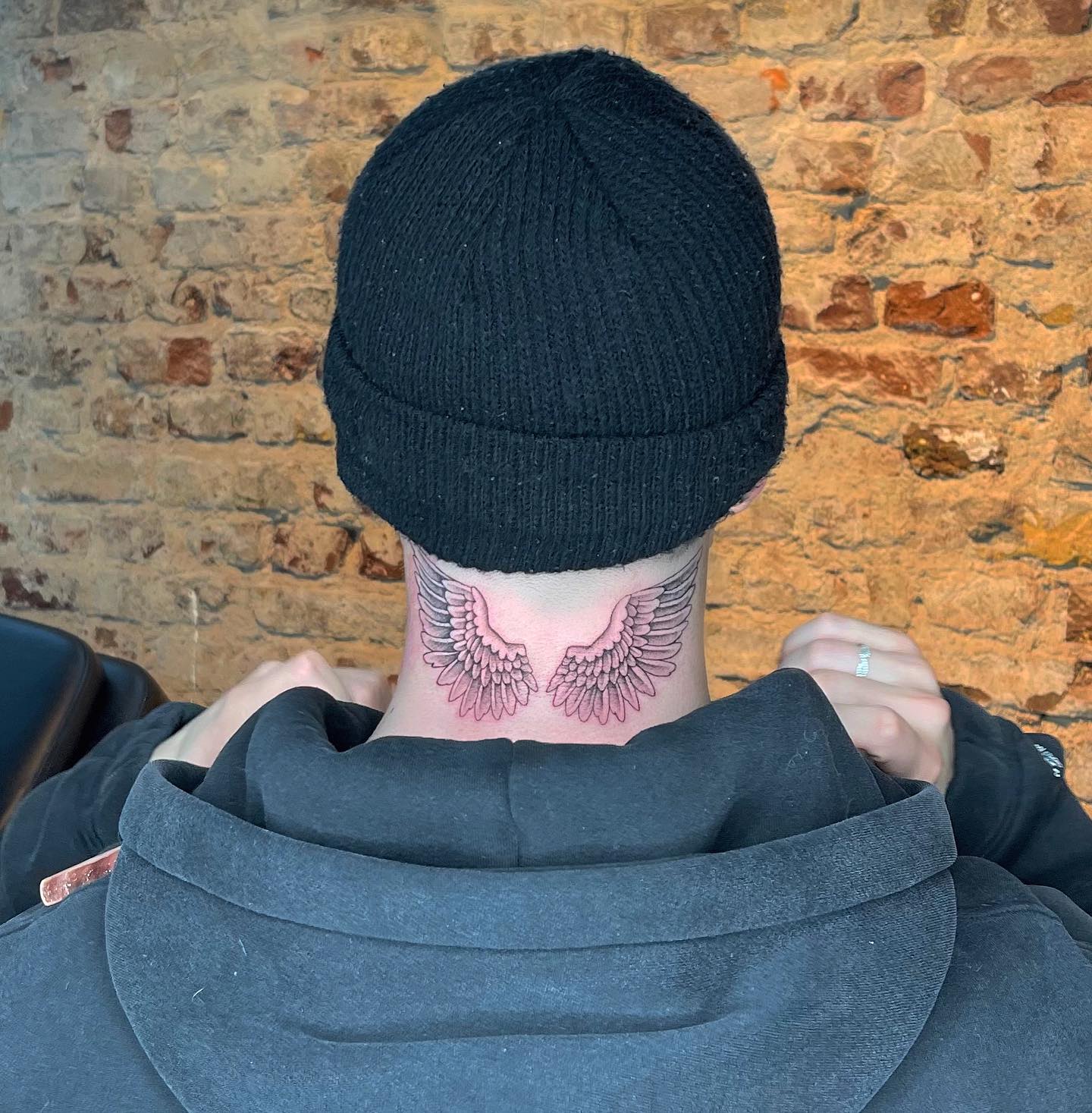 Twenty4Tim neck wings tattoo