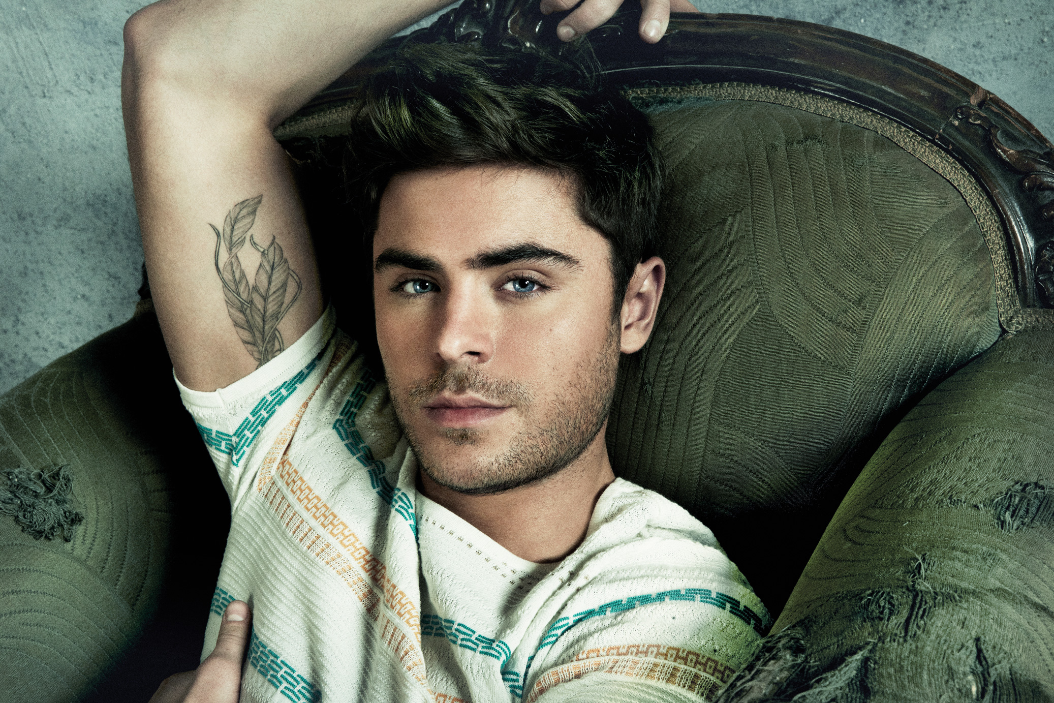 Zac Efron showing his feather tattoo