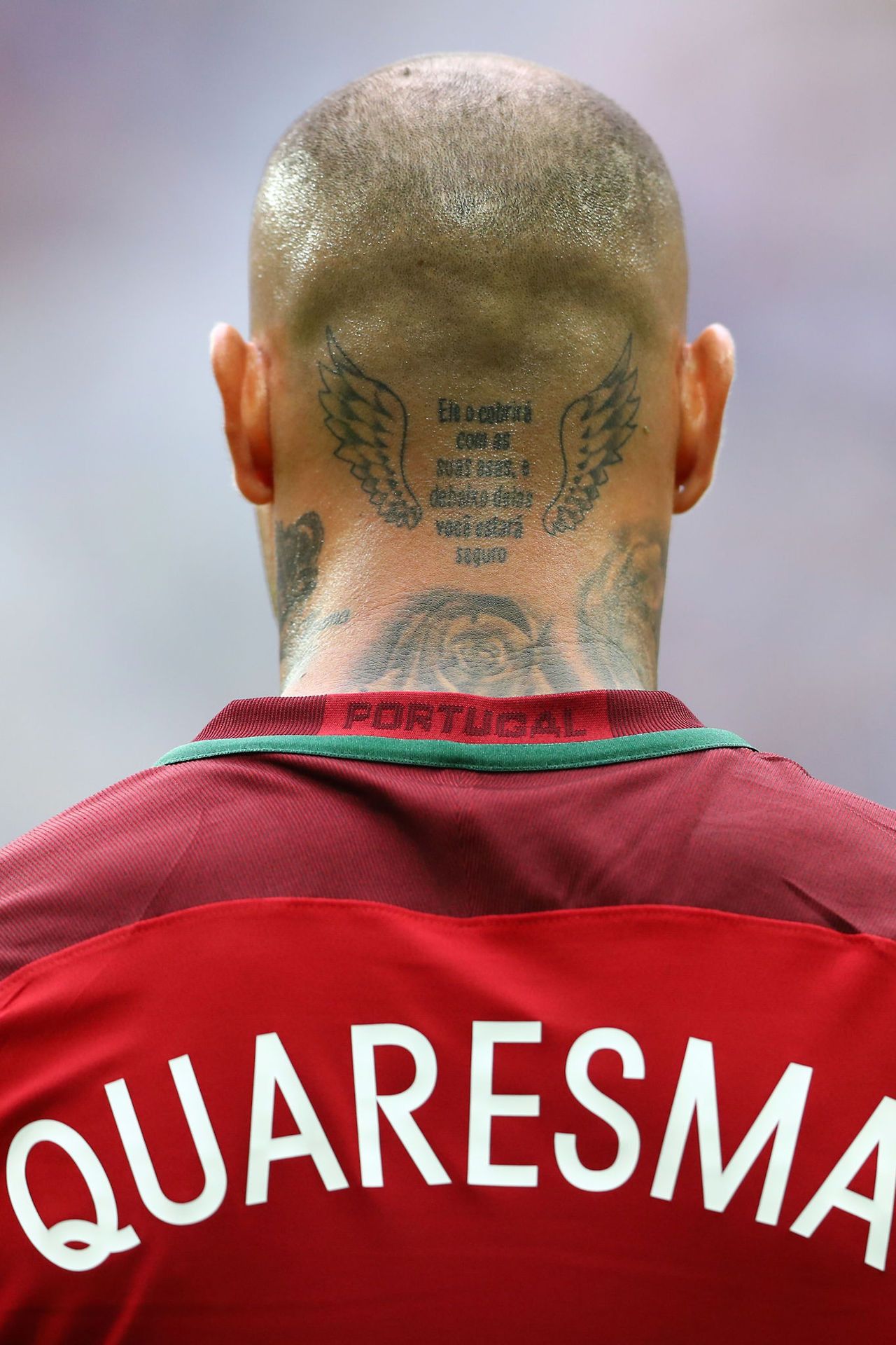 Ricardo Quaresma showing his winged neck lettering tattoo