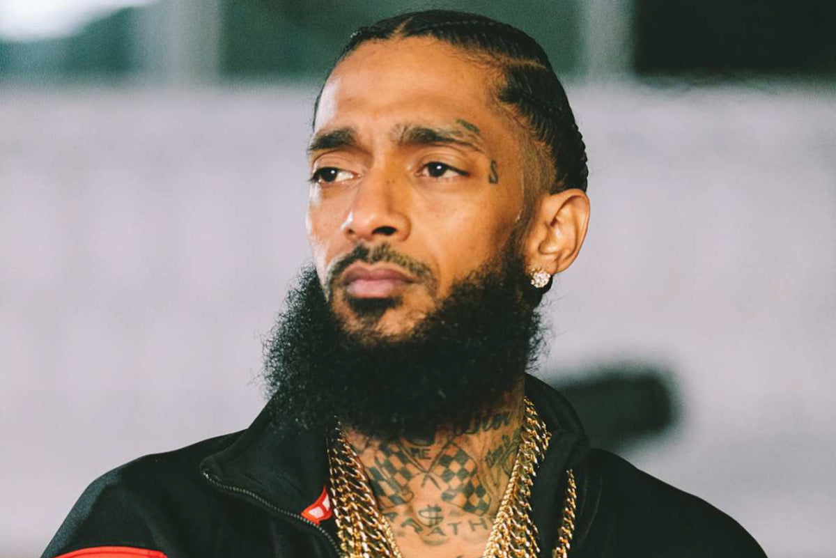 Nipsey Hussle tattoos: checkerboard neck and upper chest connection