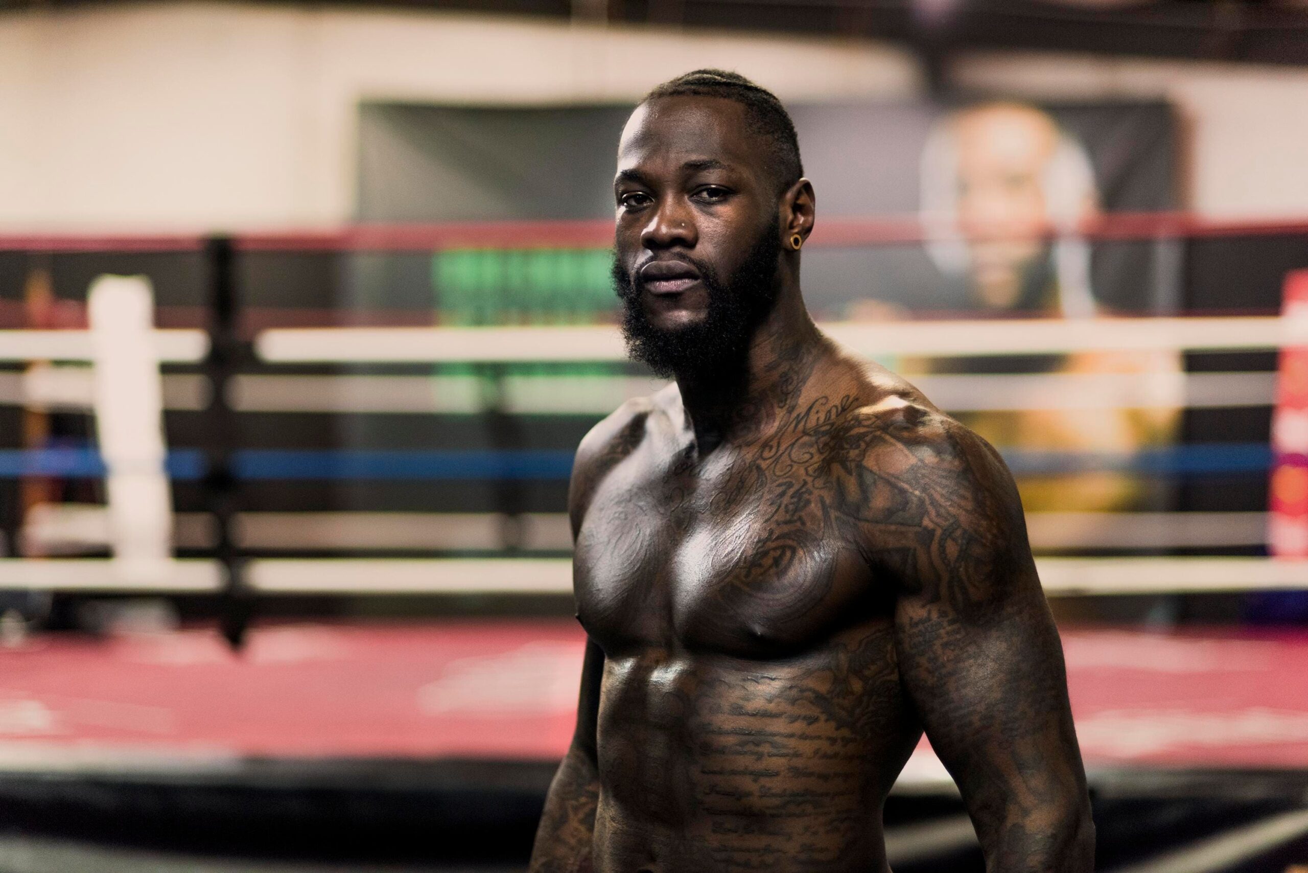 Deontay Wilder tattoos: long script and lettering across the stomach