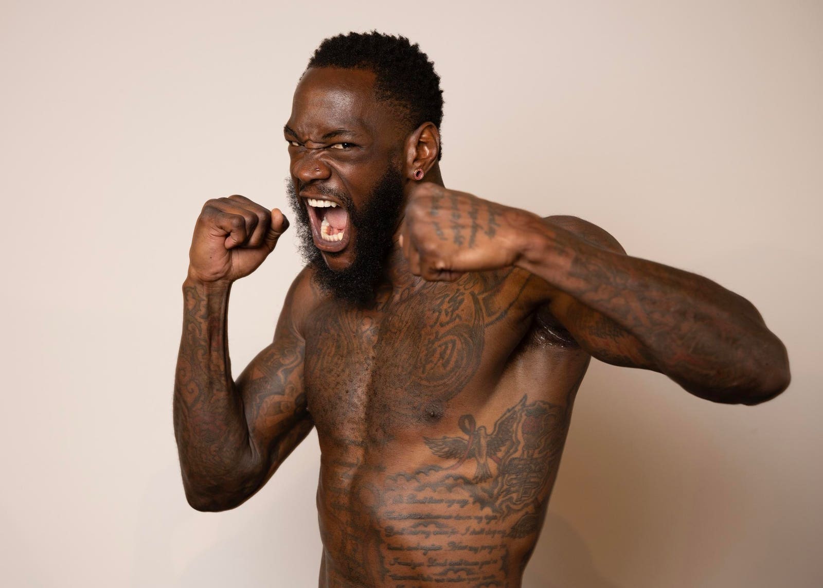 Deontay Wilder tattoos: forearm script and smaller arm tattoo details