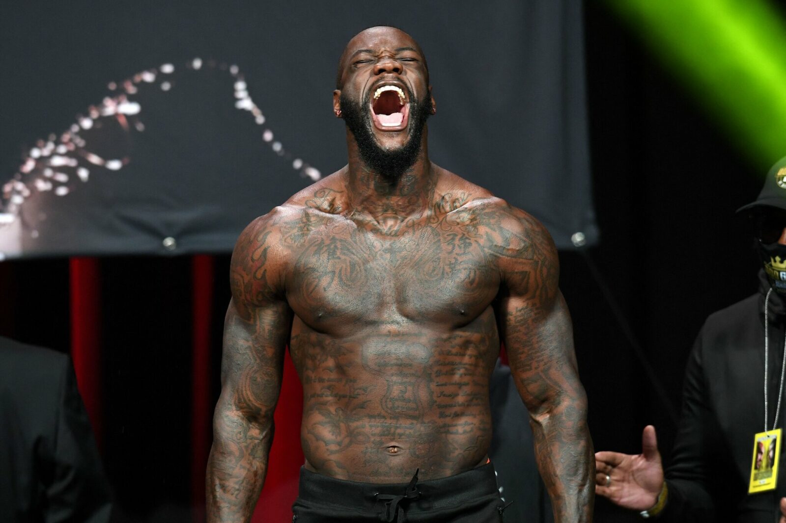 Deontay Wilder tattoos: neck lettering and upper chest tattoo transition