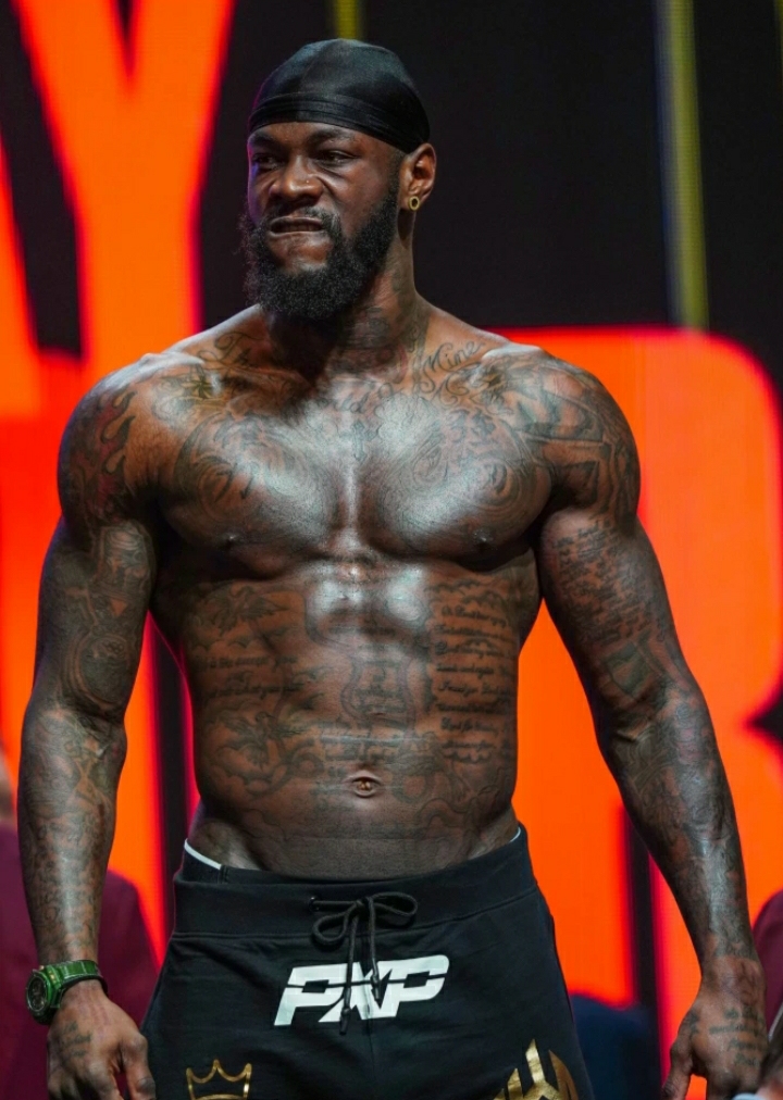 Deontay Wilder tattoos: side torso and rib tattoo coverage around the central script
