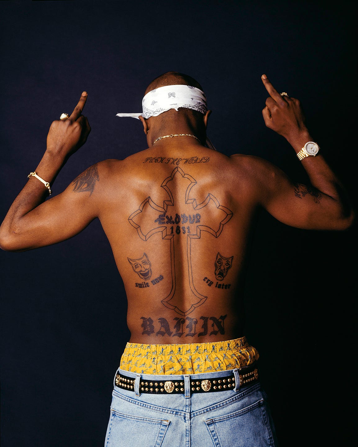 Tupac Shakur tattoos: high-resolution Chi Modu back portrait showing the large cross, Exodus lettering, theater masks and Ballin tattoo