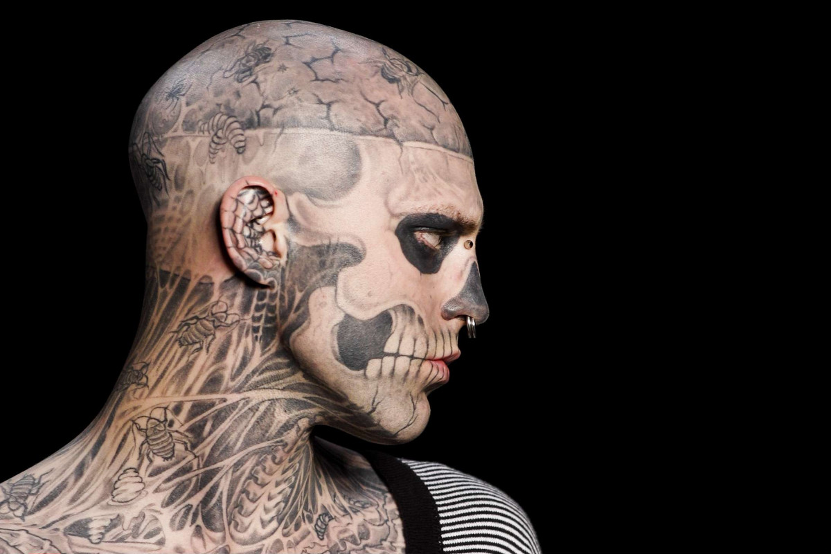 Rick Genest tattoos: clean high-resolution side profile showing the skull face, cracked scalp, insects and neck anatomy tattoos