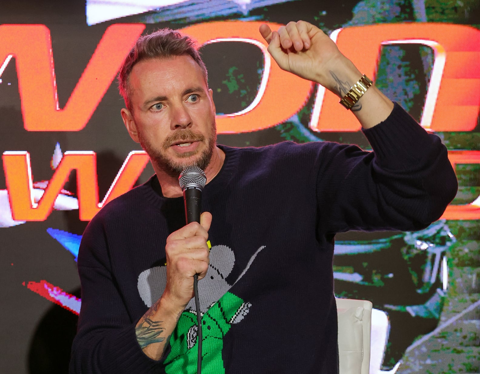 Dax Shepard tattoos: high-resolution event photograph showing the inside wrist and colorful forearm work