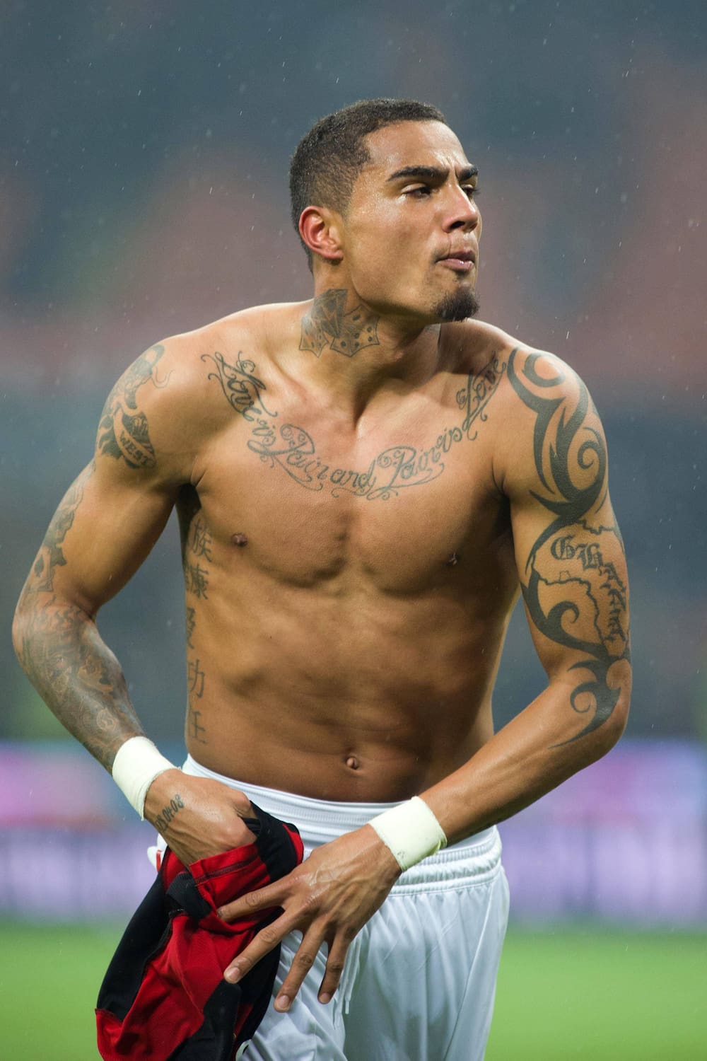 Kevin-Prince Boateng tattoos: full-body tattooed pitch portrait showing arms and torso