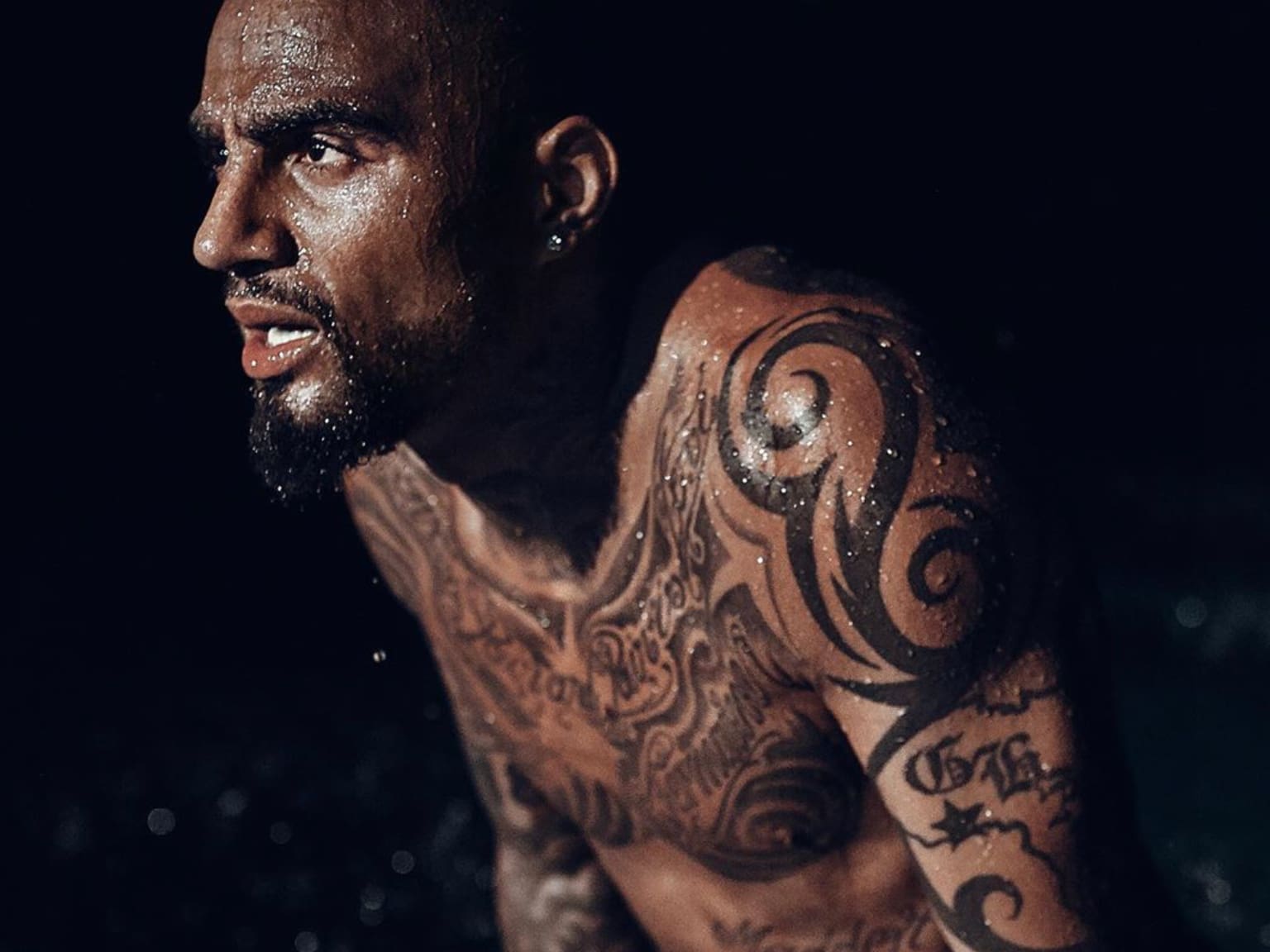 Kevin-Prince Boateng tattoos: wide tattooed torso and chest lettering